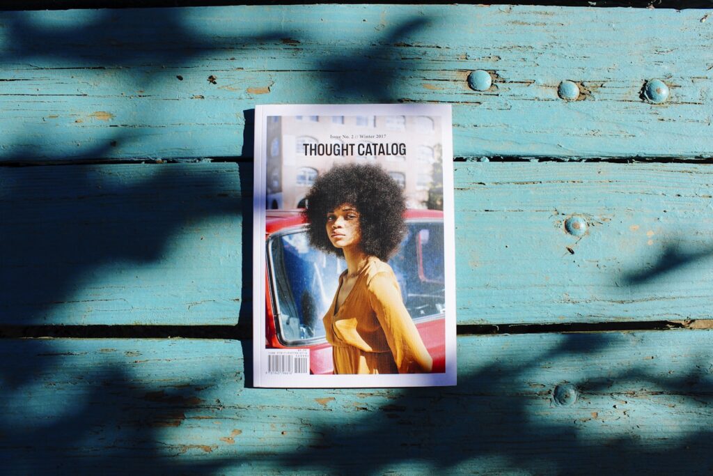 Reading a magazine at a rustic table under a tree